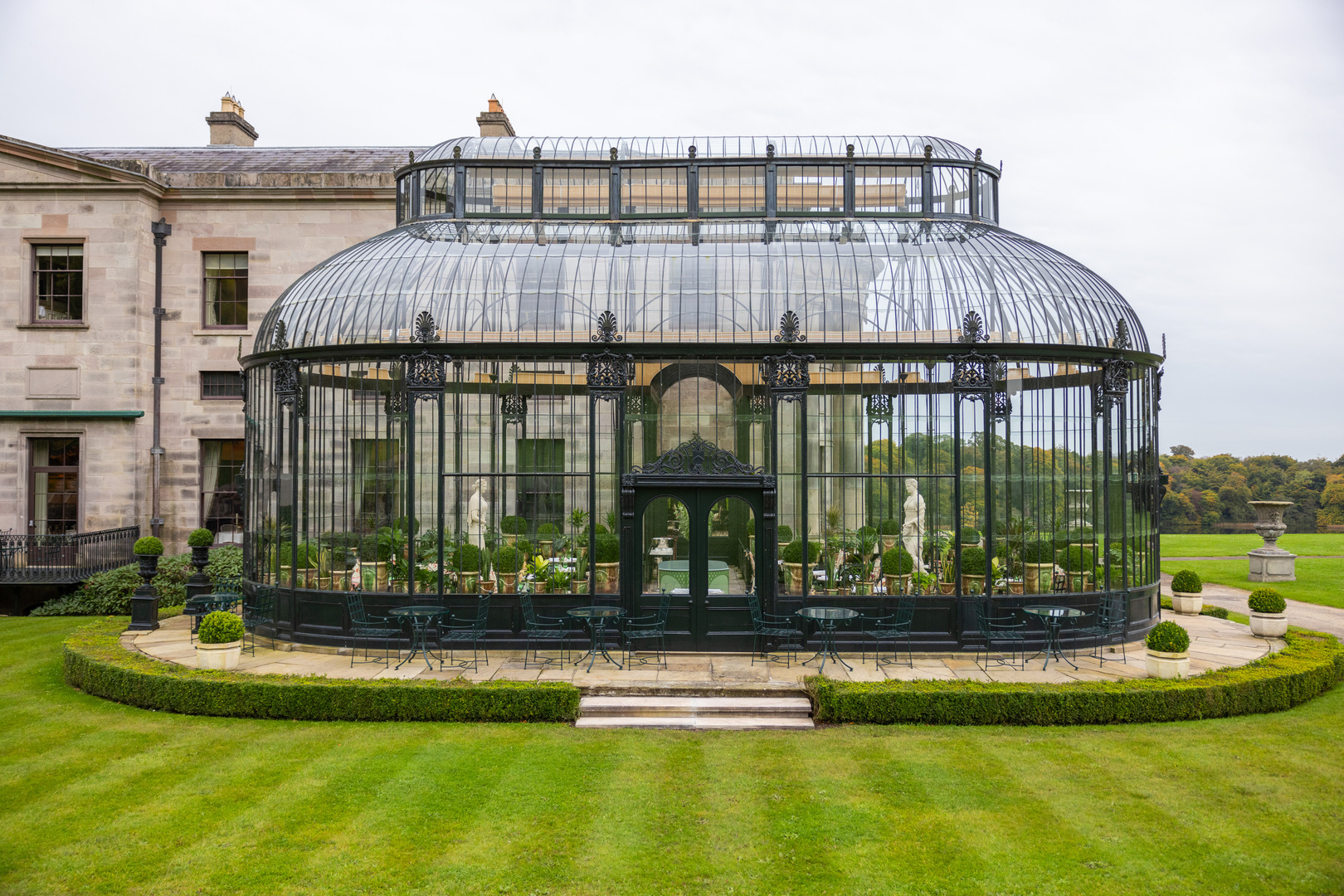 Glass conservatory with seating area.