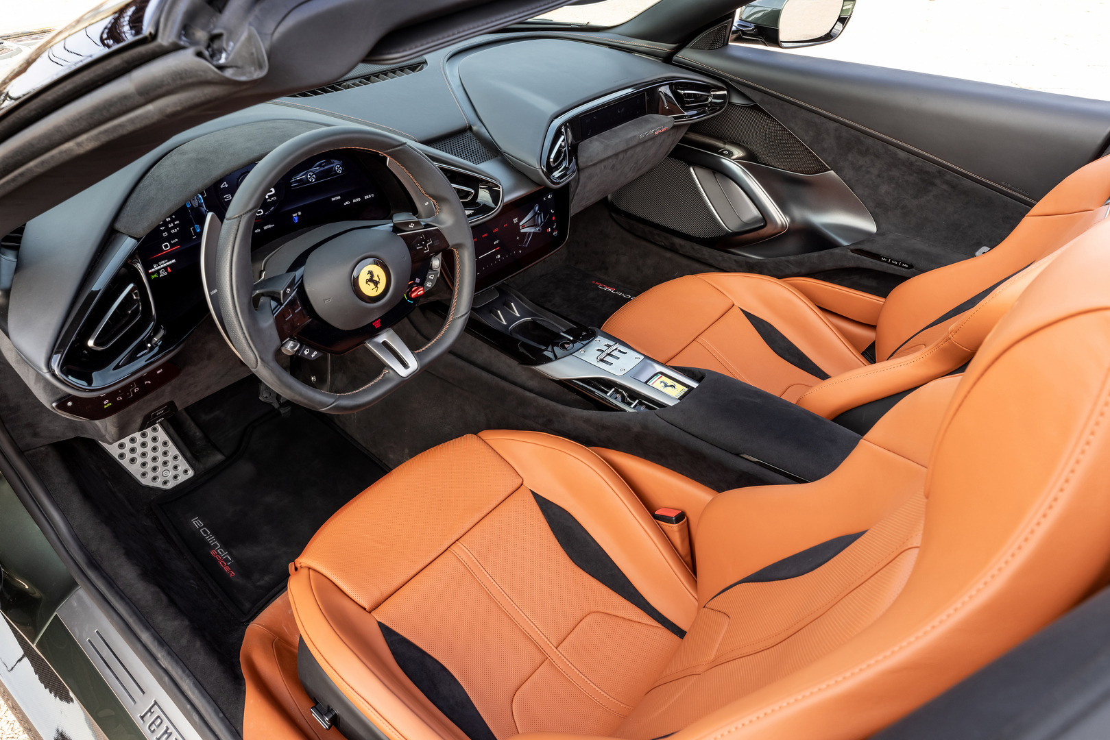 Interior of a Ferrari with orange leather seats.