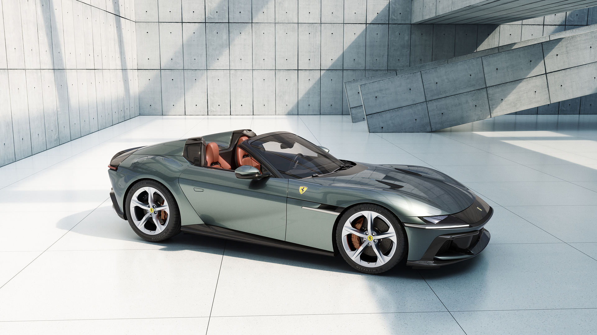 A green Ferrari convertible in a modern concrete setting.