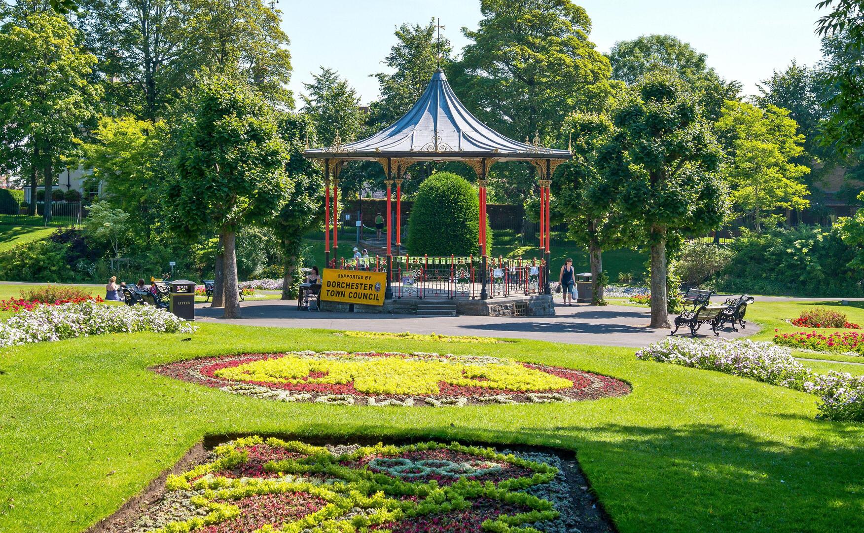 Bandstand in a park with flowerbeds.