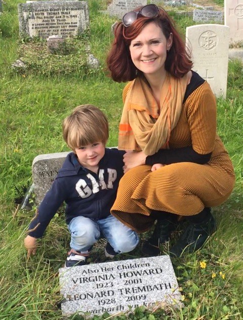 Woman and young boy at a grave.
